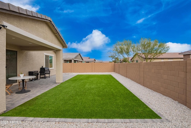 view of yard featuring a fenced backyard and a patio