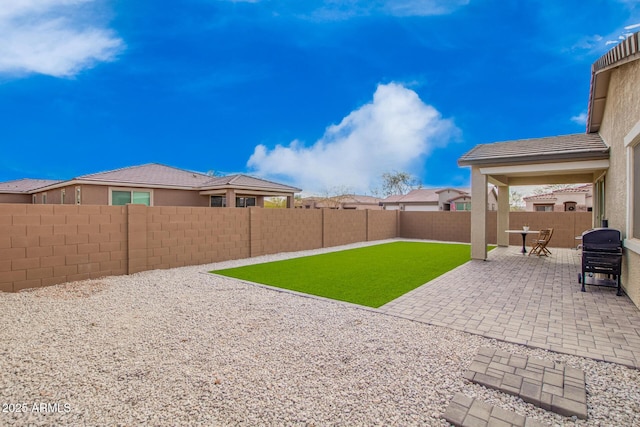 view of yard featuring a fenced backyard and a patio area