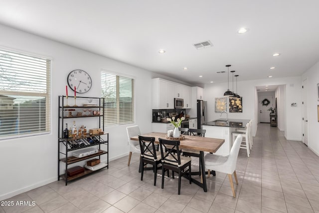 dining space with light tile patterned floors, recessed lighting, visible vents, and baseboards