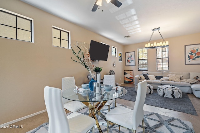 tiled dining area with ceiling fan