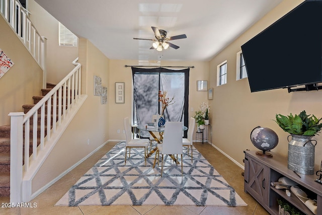 tiled dining area with ceiling fan