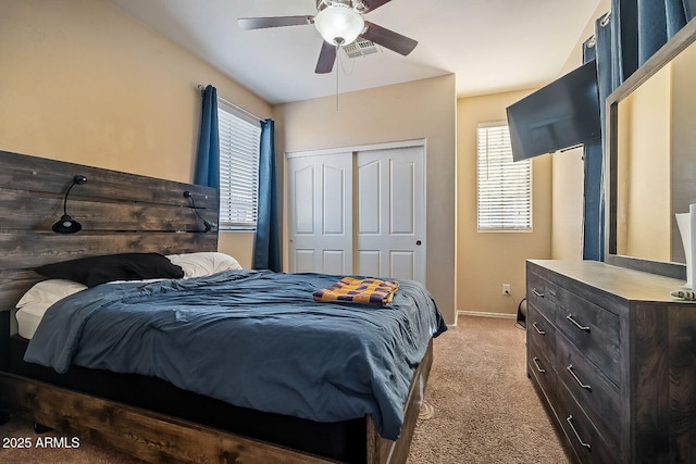 carpeted bedroom featuring ceiling fan and a closet