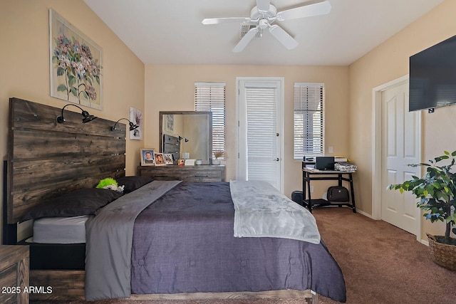 bedroom with ceiling fan and dark carpet