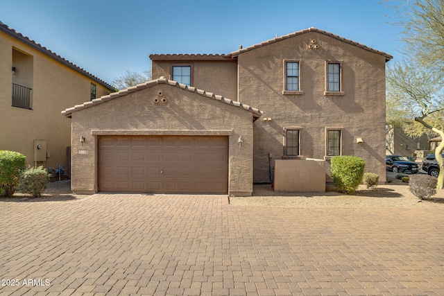 mediterranean / spanish home with a garage