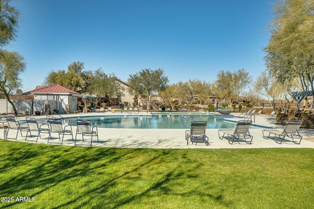 view of swimming pool featuring a lawn and a patio area