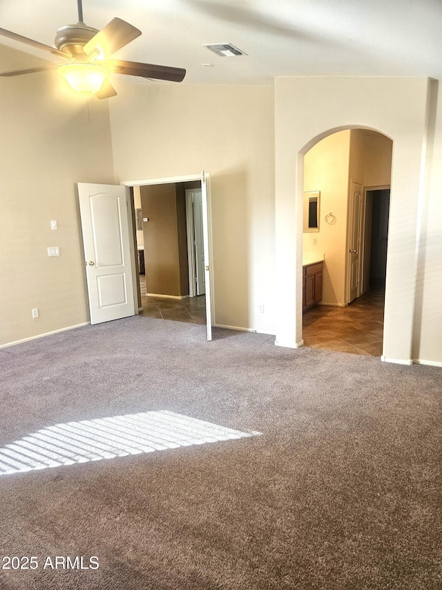 carpeted spare room featuring ceiling fan