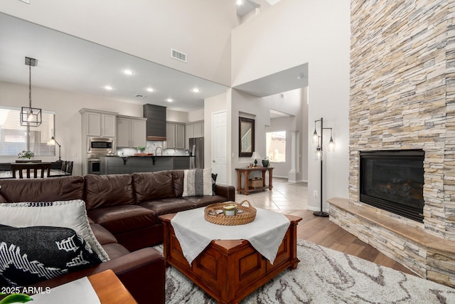 2030 W Whisper Rock Trl, Phoenix, AZ 85085 - living area with light wood-style floors and a fireplace