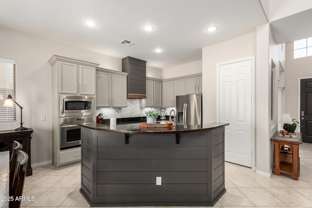 2030 W Whisper Rock Trl, Phoenix, AZ 85085 - kitchen featuring appliances with stainless steel finishes, gray cabinets, dark stone countertops, light tile patterned flooring, and recessed lighting