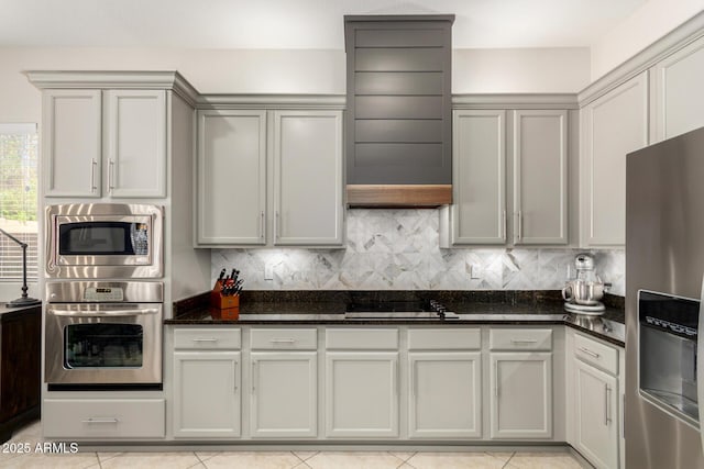 2030 W Whisper Rock Trl, Phoenix, AZ 85085 - kitchen with stainless steel appliances, dark stone counters, light tile patterned floors, gray cabinetry, and backsplash