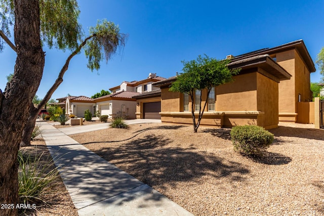 2030 W Whisper Rock Trl, Phoenix, AZ 85085 - view of front facade with stucco siding, a tile roof, driveway, and an attached garage