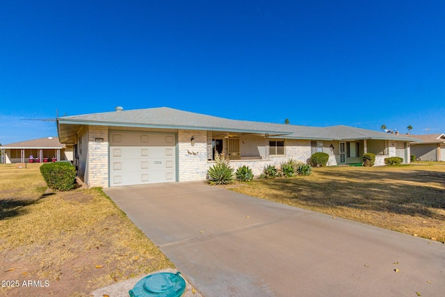 ranch-style house featuring a front lawn and a garage