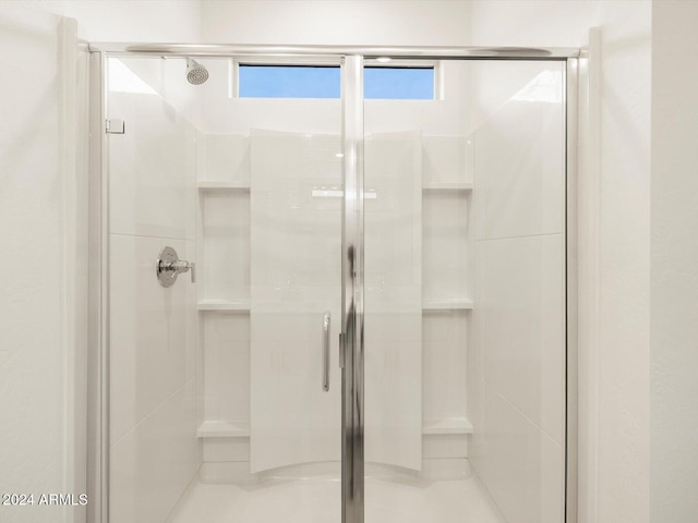 bathroom with a shower with shower door