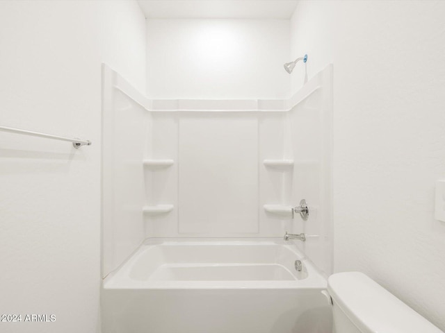 bathroom with bathing tub / shower combination and toilet