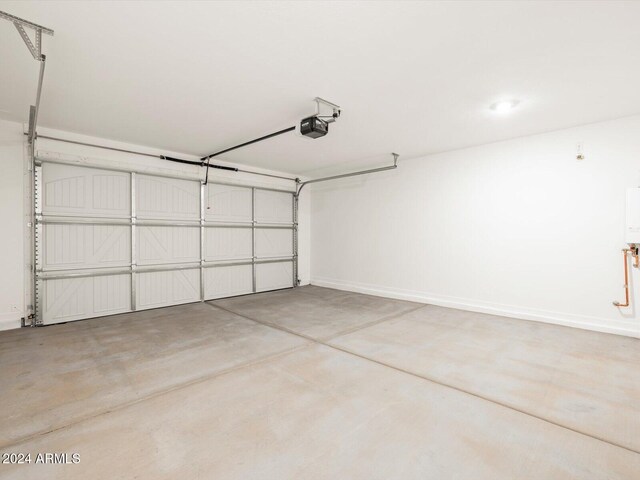 garage with a garage door opener and baseboards