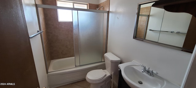 full bathroom with tile patterned flooring, toilet, combined bath / shower with glass door, and sink