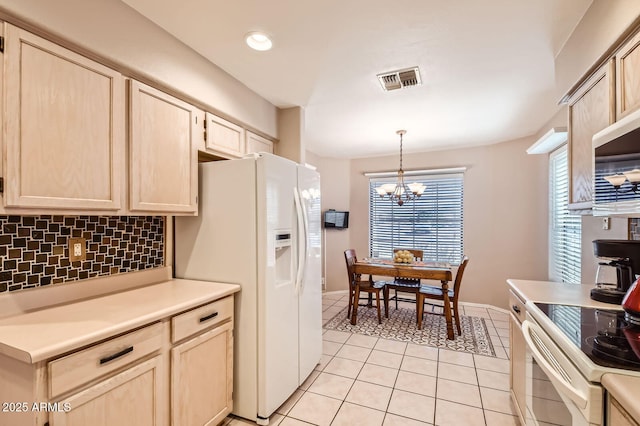 kitchen with light brown cabinets, white appliances, a chandelier, light tile patterned floors, and backsplash
