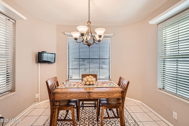 dining room featuring an inviting chandelier, plenty of natural light, and light tile patterned flooring