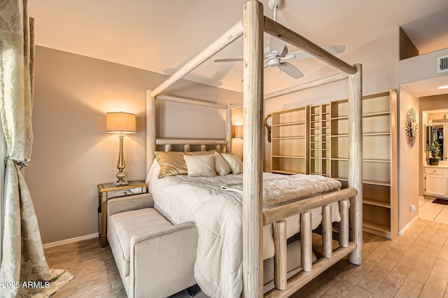 bedroom with light wood-style floors, baseboards, connected bathroom, and visible vents
