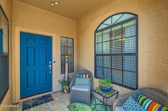doorway to property featuring stucco siding