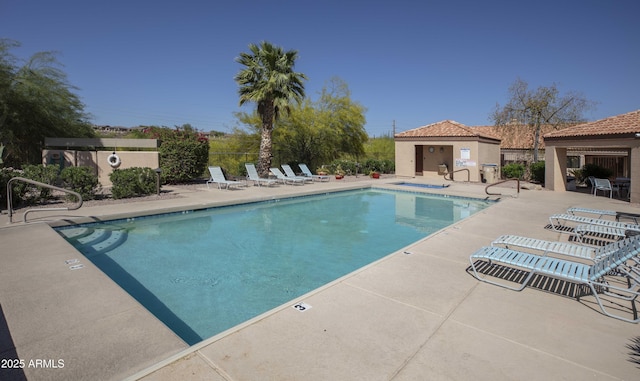 pool with fence and a patio area