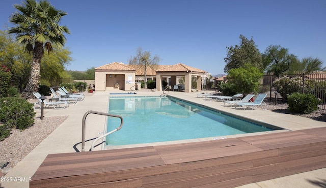 community pool featuring a patio, a gazebo, and fence