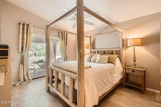 bedroom featuring baseboards, access to outside, vaulted ceiling, and wood finished floors