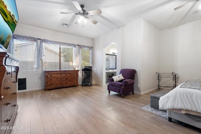 bedroom featuring ceiling fan, ensuite bath, and light hardwood / wood-style flooring