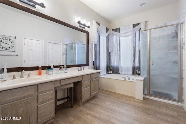 bathroom featuring vanity, hardwood / wood-style flooring, and separate shower and tub