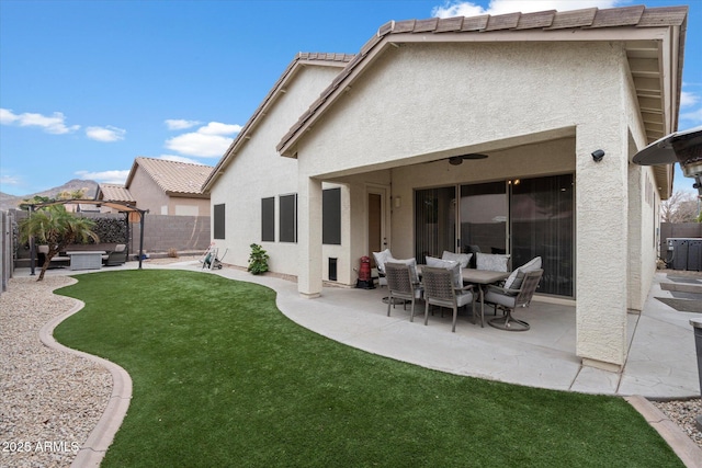 back of house with a gazebo, a patio area, and a lawn