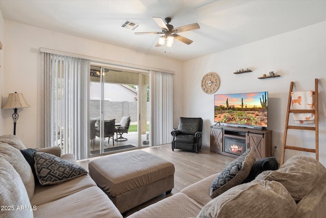 living room featuring ceiling fan and light wood-type flooring