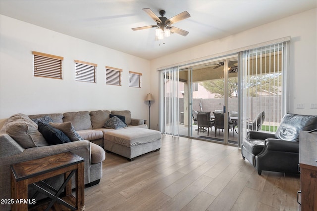 living room featuring ceiling fan and light hardwood / wood-style flooring