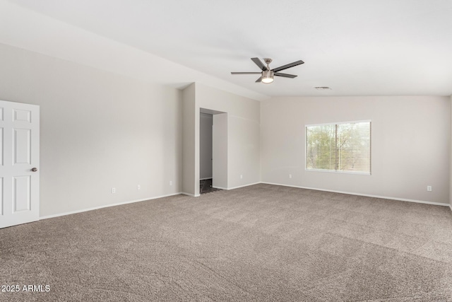 spare room featuring carpet, baseboards, visible vents, lofted ceiling, and ceiling fan