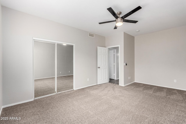 unfurnished bedroom with visible vents, a ceiling fan, a closet, carpet floors, and baseboards