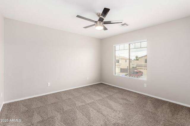 empty room featuring visible vents, baseboards, a ceiling fan, and carpet flooring