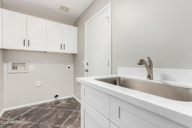 washroom with visible vents, washer hookup, cabinet space, electric dryer hookup, and a sink