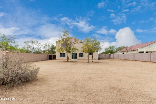 back of property with a fenced backyard