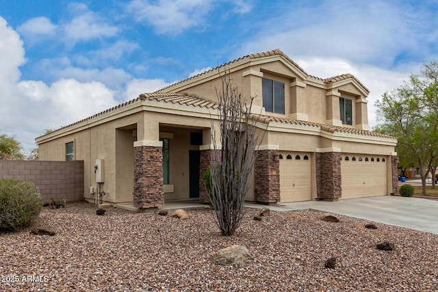 mediterranean / spanish-style house featuring stone siding, stucco siding, driveway, and a garage