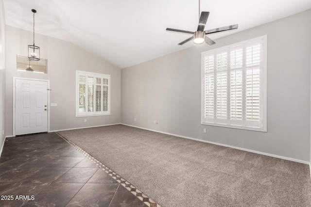 interior space featuring vaulted ceiling, baseboards, a wealth of natural light, and ceiling fan