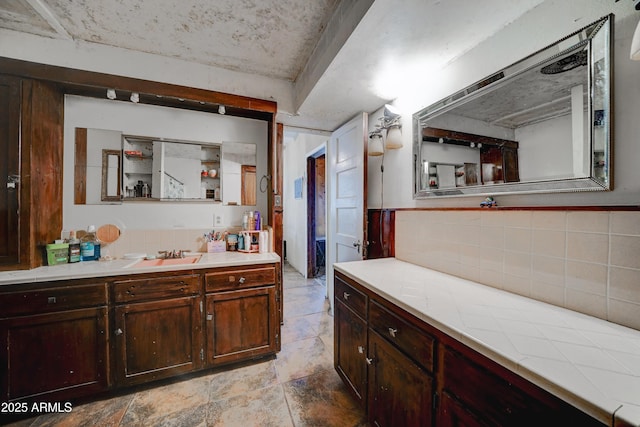 bathroom featuring vanity and decorative backsplash