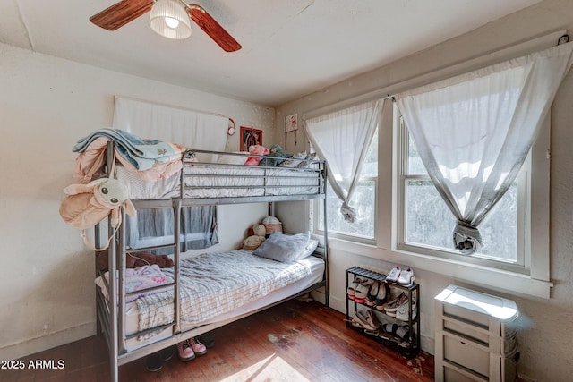 bedroom featuring dark hardwood / wood-style floors and ceiling fan