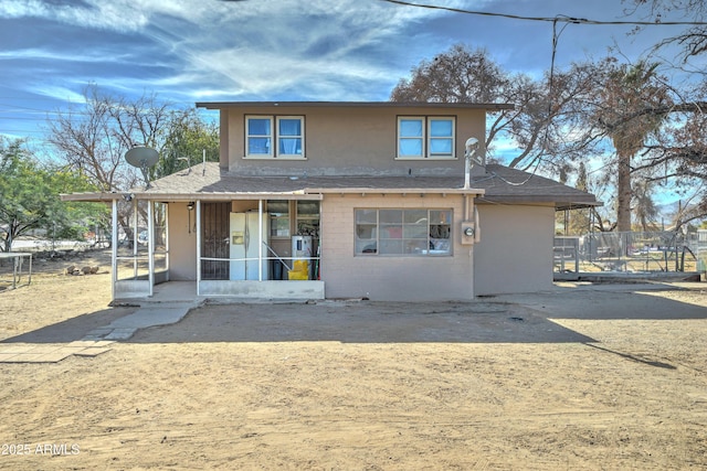 rear view of property with a sunroom