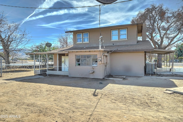 rear view of house with a patio area and a trampoline