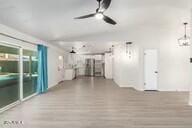 interior space with ceiling fan and light hardwood / wood-style flooring