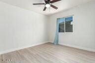 empty room with hardwood / wood-style floors and ceiling fan