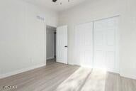 unfurnished bedroom featuring light wood-type flooring and a closet