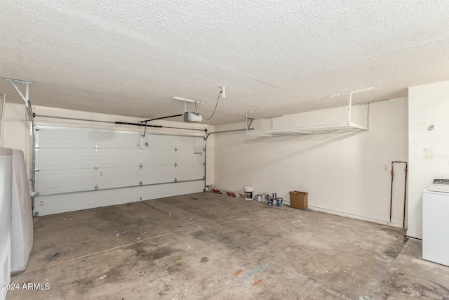 garage with washer / dryer and a garage door opener