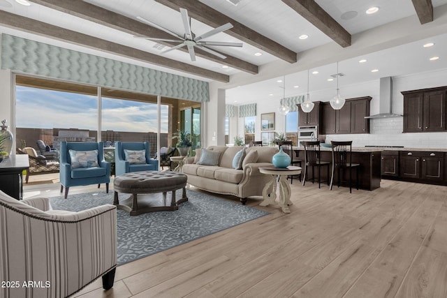 living room with light wood-style floors, ceiling fan, beamed ceiling, and recessed lighting