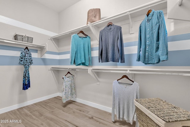 spacious closet featuring visible vents and wood finished floors