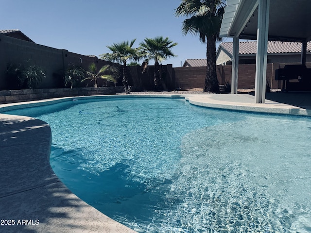 view of swimming pool featuring a patio, a fenced in pool, and a fenced backyard
