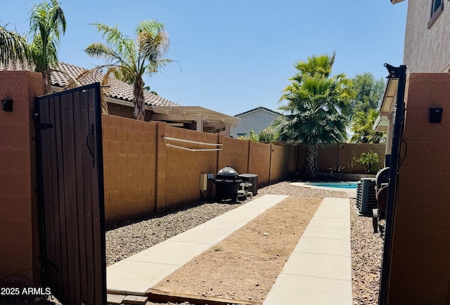 view of yard featuring central air condition unit and a fenced backyard